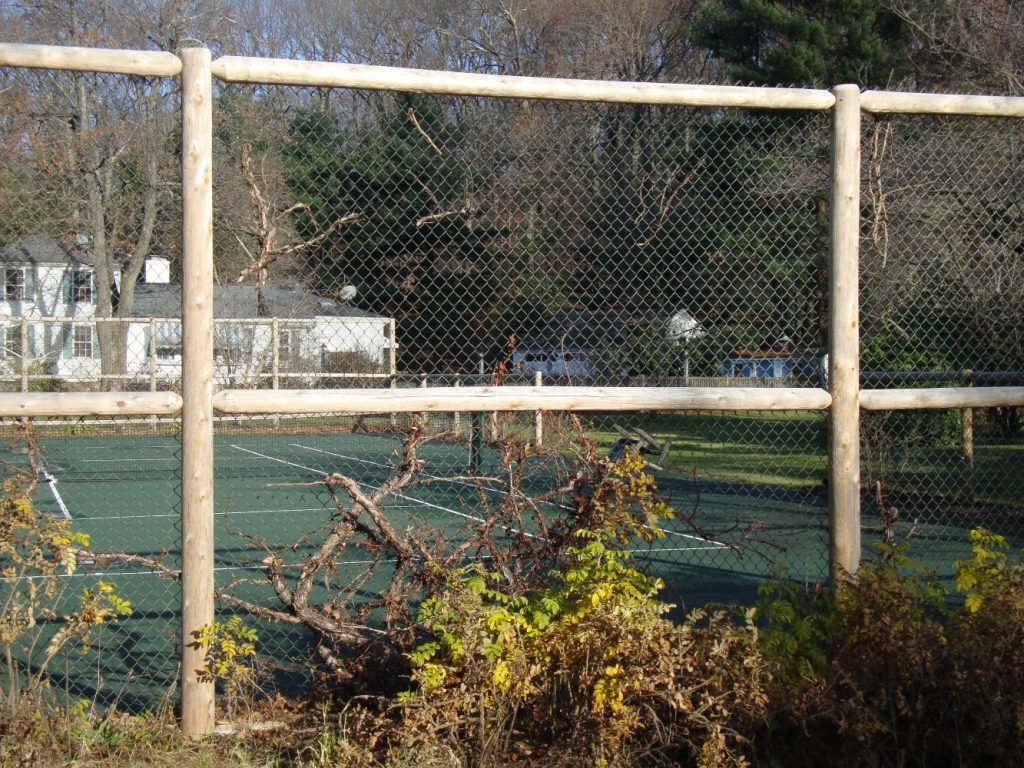 Tennis court enclosureround cedar posts, round dowel rails with chain